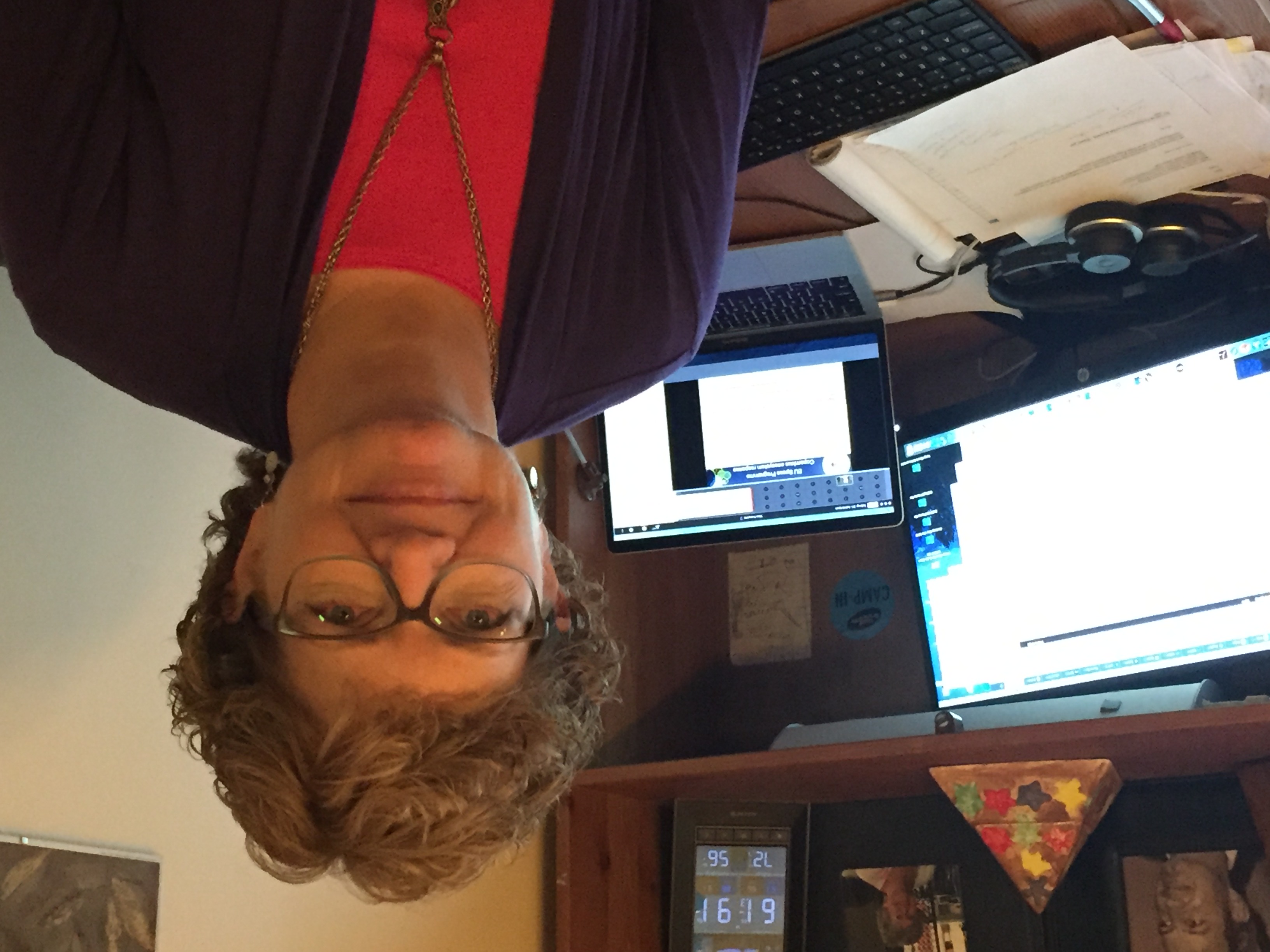 woman smiling in front of desk and computer