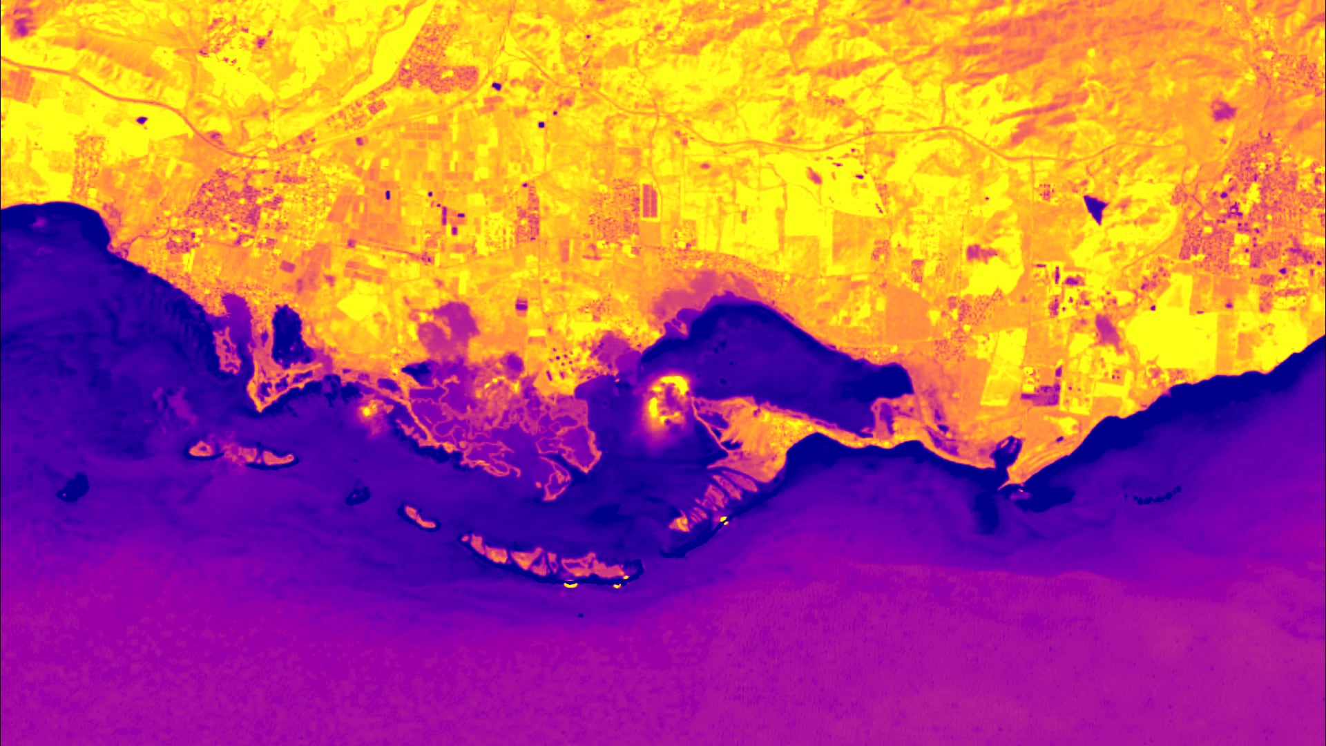 Modified Normalized Difference Water Index (MNDWI)-processed imagery of Jobos Bay, Puerto Rico, using Landsat 8 OLI data from 2020. In order to detect shoreline change over time, MNDWI was used with thresholding techniques to classify water and land in the area from 1997 to 2020. Dark purple areas show water and yellow represents land. Classifying water and land over the study period allows partners to quantify change and potential impacts of sea level rise.  Keywords: Landsat, MNDWI