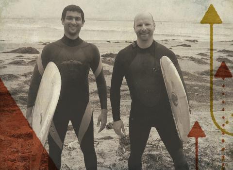 Image of Viral and a friend on the beach with surf boards