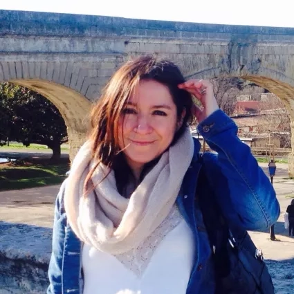 Photo of woman in front of bridge