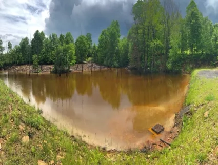 Abandoned mine land site with stained rocks from acid mine drainage