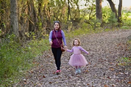 woman and child walking on a trail