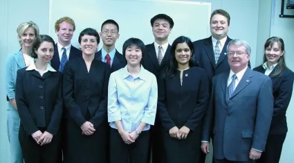 11 people standing together for a team photo