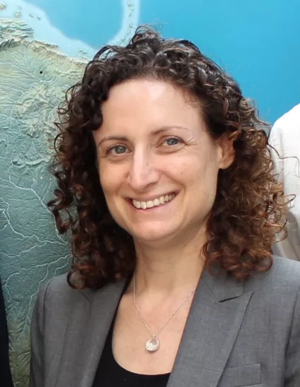 Woman with curly hair smiles for portrait