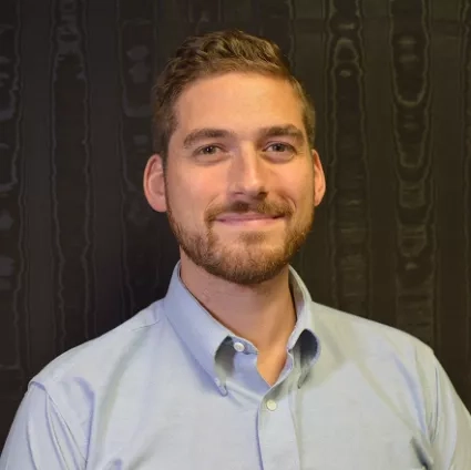 Man with beard smiles for portrait