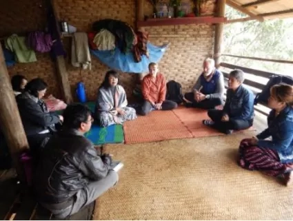 several adults sitting in a semi circle on the floor