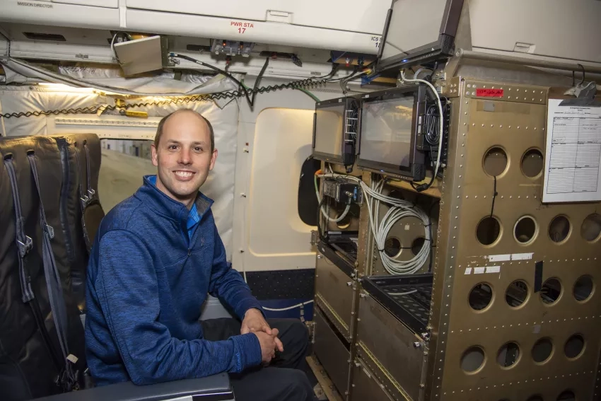 Photo of scientist Kristopher Bedka with laser