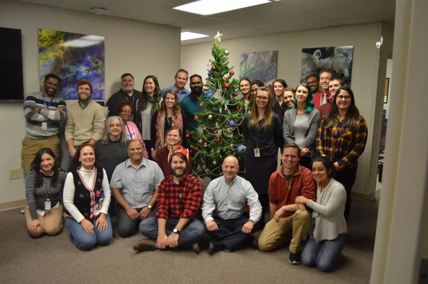 Photo of people in front of tree inside