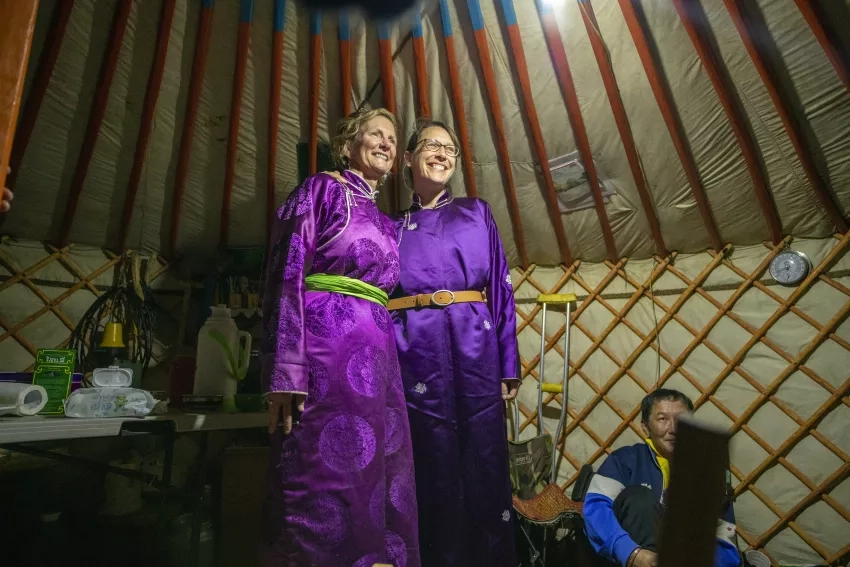 photo of women in purple dresses