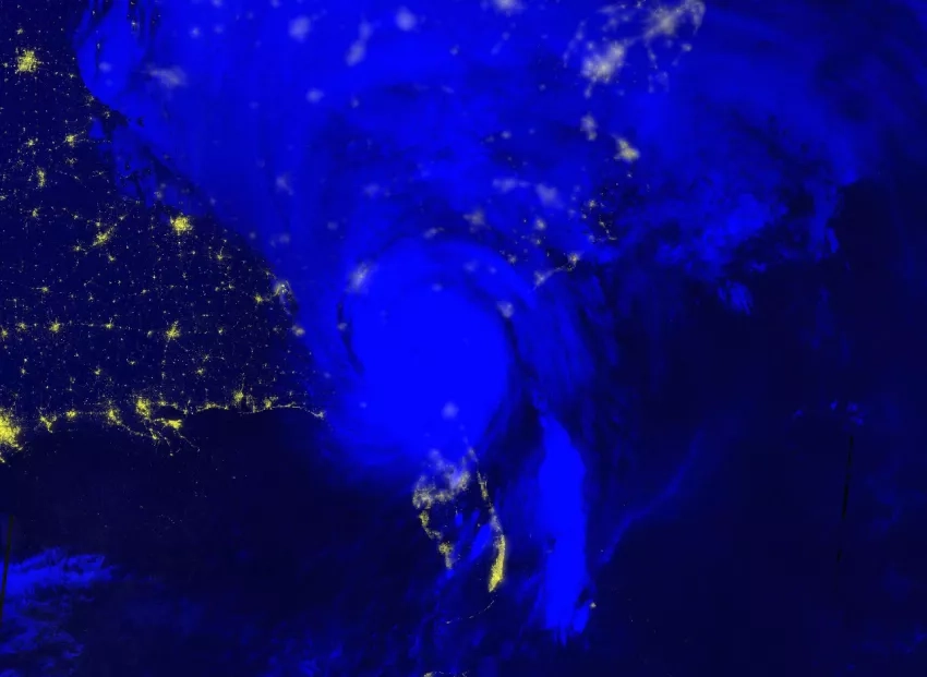 Satellite map showing nighttime lights from Hurricane Helene, with the storm showing as a large light-blue swirling mass over northern Florida.