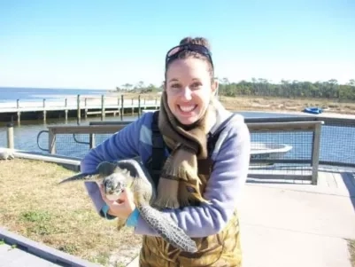 Paris carries a sea turtle that she rescued while volunteering with Florida Fish and Wildlife. Record-cold temperatures caused turtles to surface, unable to swim, so she helped transport them to a local aquarium for rehabilitation and release. As a disaster management coordinator for NASA’s Disasters program area, Paris combines her passions for the environment and community disaster resilience. Credits: Jennifer Paris/NASA