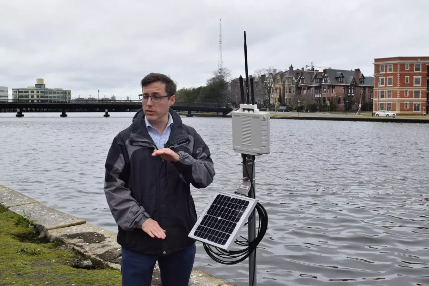 Kyle Spencer shows off a water sensor on the Hague lake in Norfolk, Virginia