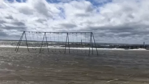 GIF of swing set flooded