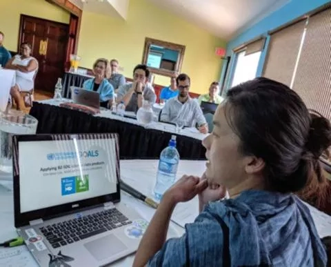 Photo of Christine Lee in front of computer in 2019