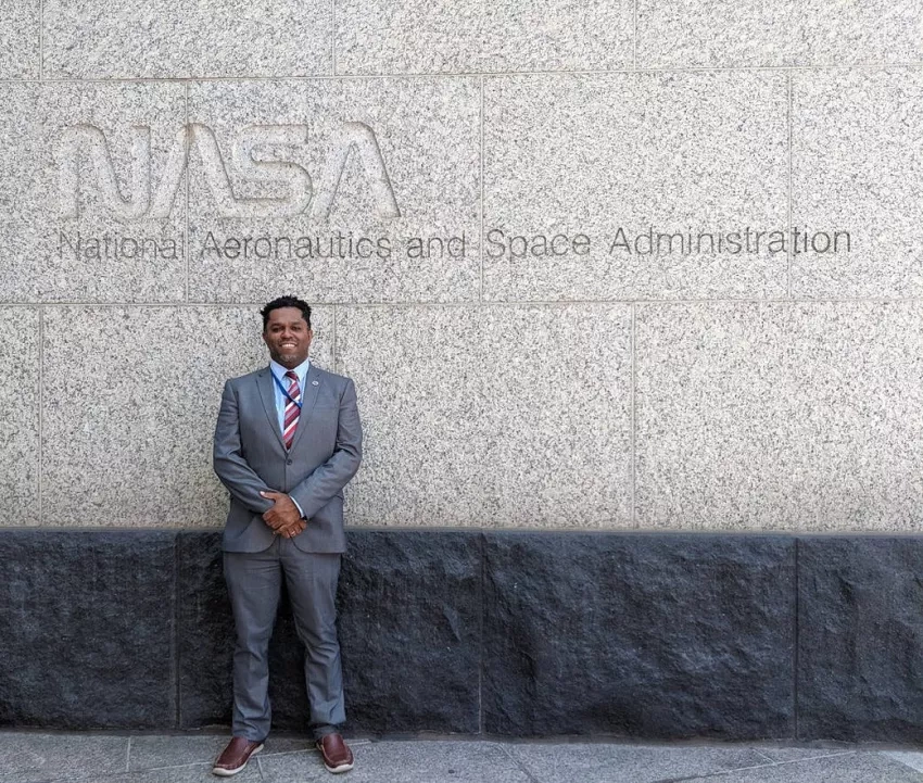 photo of man in front of wall