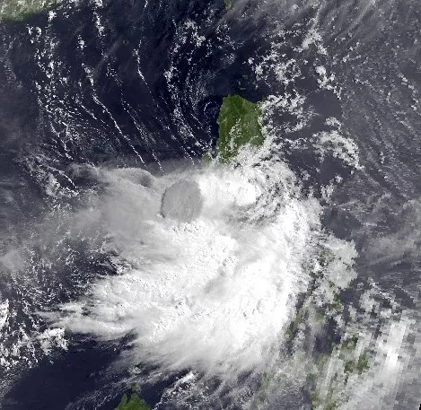 Image: Tropical Storm Yunya arrives about 5 miles away from land in this image taken by the NOAA-12 satellite on June 14, 1991.  The eruption column from Mt. Pinatubo (in dark grey) can be seen through the storm's clouds. Credits: NOAA