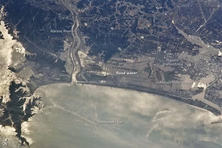 On Mar. 11, 2011, the eastern coast of Japan was shaken by the magnitude 9.0 Tohoku earthquake - one of the strongest earthquakes ever recorded. This photo, taken from the International Space Station on Mar. 13, 2011, shows the Japanese coastline north and east of Sendai following inundation by a tsunami. Sunglint indicates the widespread presence of floodwaters and indicates oils and other materials on the water surface.. Credit: NASA