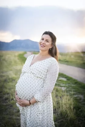 pregnant woman standing in a field