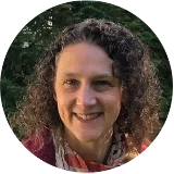 photo of white woman with dark curly hair smiling