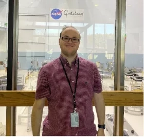 photo of man standing in front of window