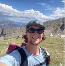 photo of man in baseball hat outside