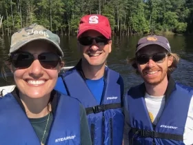 photo of three white people in hats and sunglasses