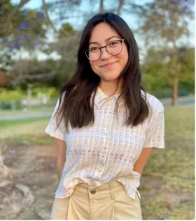 photo of smiling woman in glasses standing outside