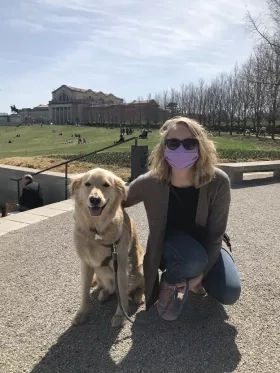 photo of woman in mask with dog