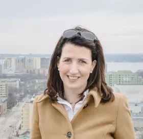 woman smiling for picture outside