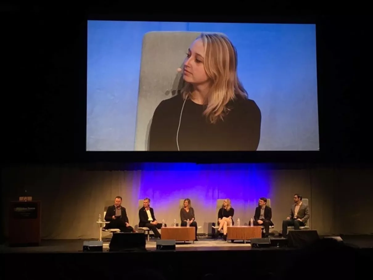 photo of people on stage sitting