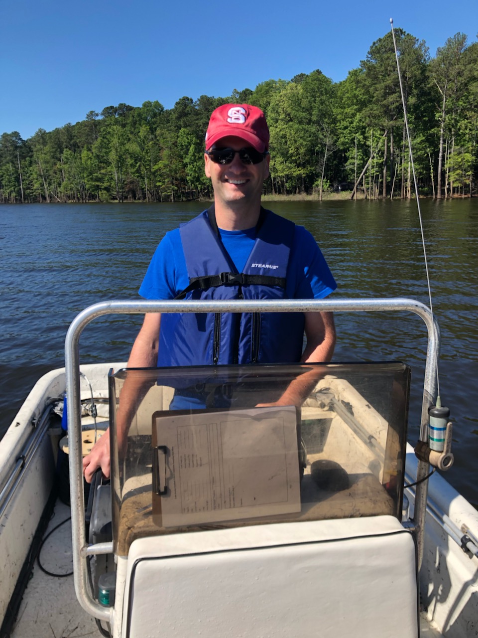 Man driving boat on lake