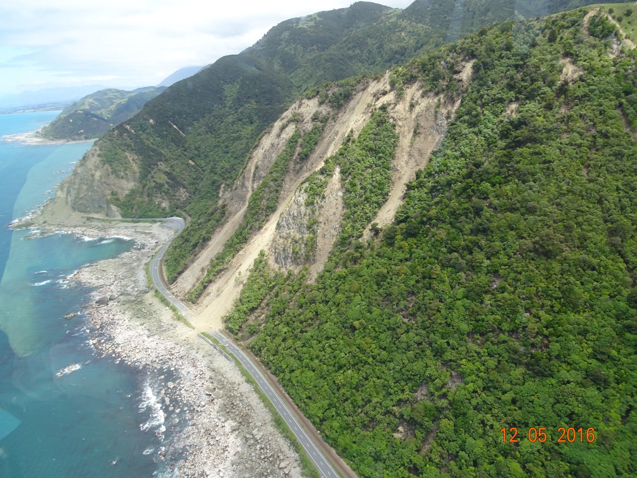 Photograph showing landslides covering State Route 1 near Ohau Point, New Zealand. Credits: USGS, Jonathan Godt