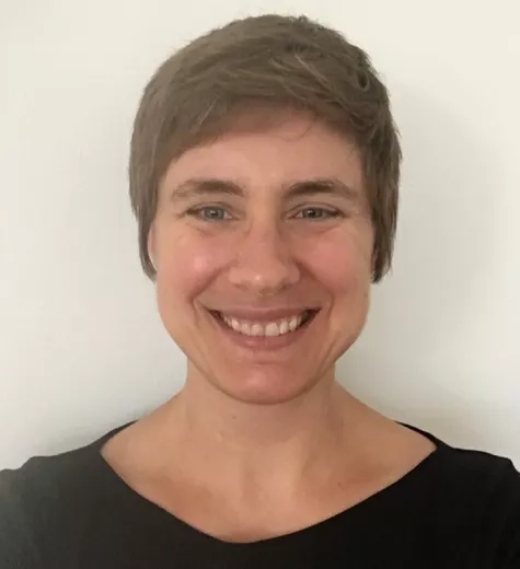 photo of white woman with short brown hair smiling at the camera