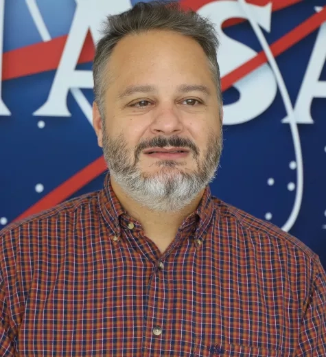 Image of David Barbato in front of the traditional NASA logo