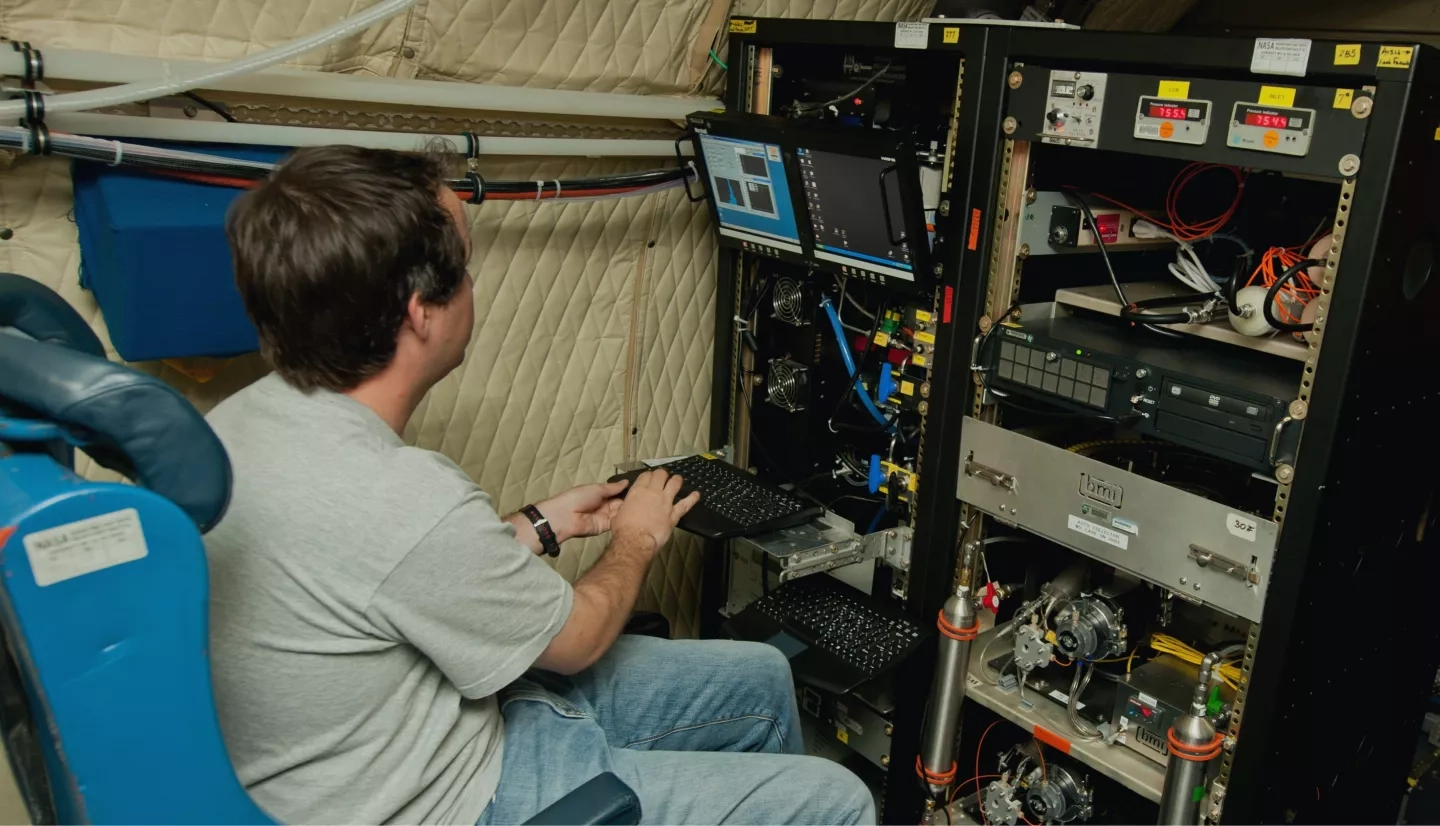 An unidentified researcher works aboard the P-3B NASA research aircraft at Baltimore/Washington International Thurgood Marshall Airport,