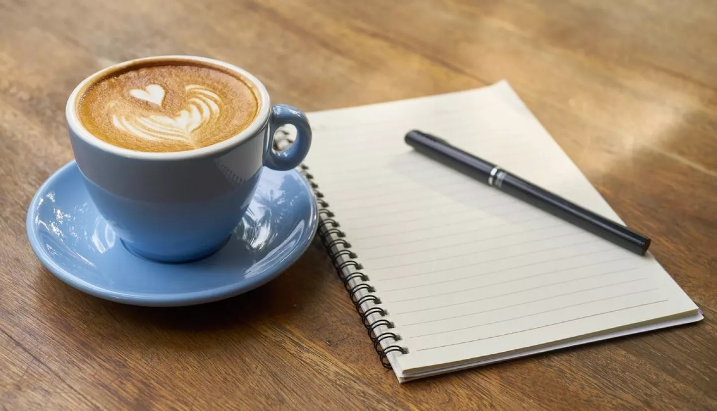 Cup of coffee and notebook