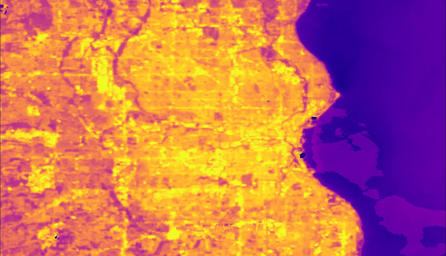 This image of Land Surface Temperature (LST) illustrates the urban heat island (UHI) effect that Milwaukee County experiences. Light orange areas represent hotter temperatures, which are concentrated in the high impervious areas of the city. Darker pinks represent cooler rural areas and underscore the temperature contrast across the landscape. The hotter areas of the city are historically redlined communities of color that disproportionately feel the effects of the UHI, including higher energy bills heat re