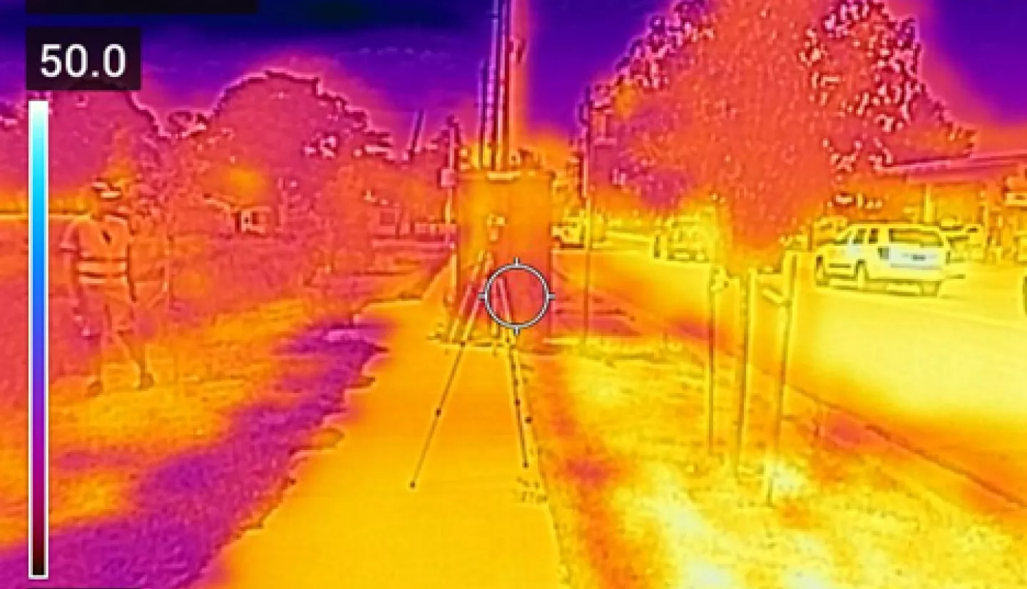 Thermal imagery of Denver bus stop in the afternoon displaying large variability in surface temperatures due to land cover types and shading. Tripods in center of image are recording wet and dry globe temperatures and windspeed. Combining fine-scale surface temperature data, with high-resolution land cover data, we can build a land cover regression to downscale Landsat thermal imagery for all metropolitan transit locations in Denver.  