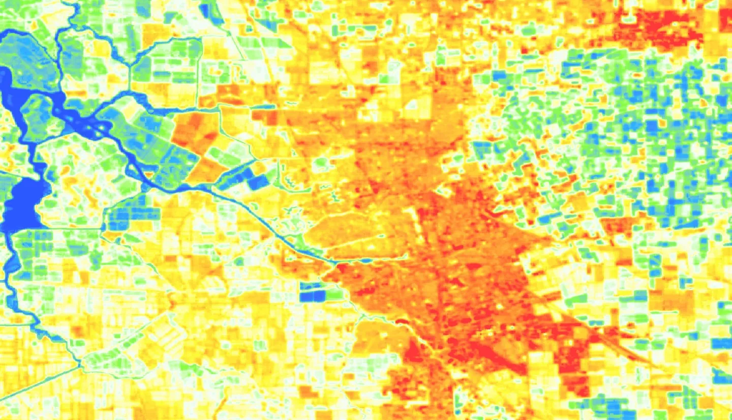 Summer 2013 - 2023 composite land surface temperature (LST) processed imagery from Landsat 8 TIRS showing Stockton, CA. Shades of dark blue, light blue, and green indicate lower temperatures, while yellow, orange, and red areas show hotter, less vegetated land. Areas with high LST are often significantly developed and prone to poor air quality because of transportation corridors, leading to interest from the community to provide solutions for cooling strategies.