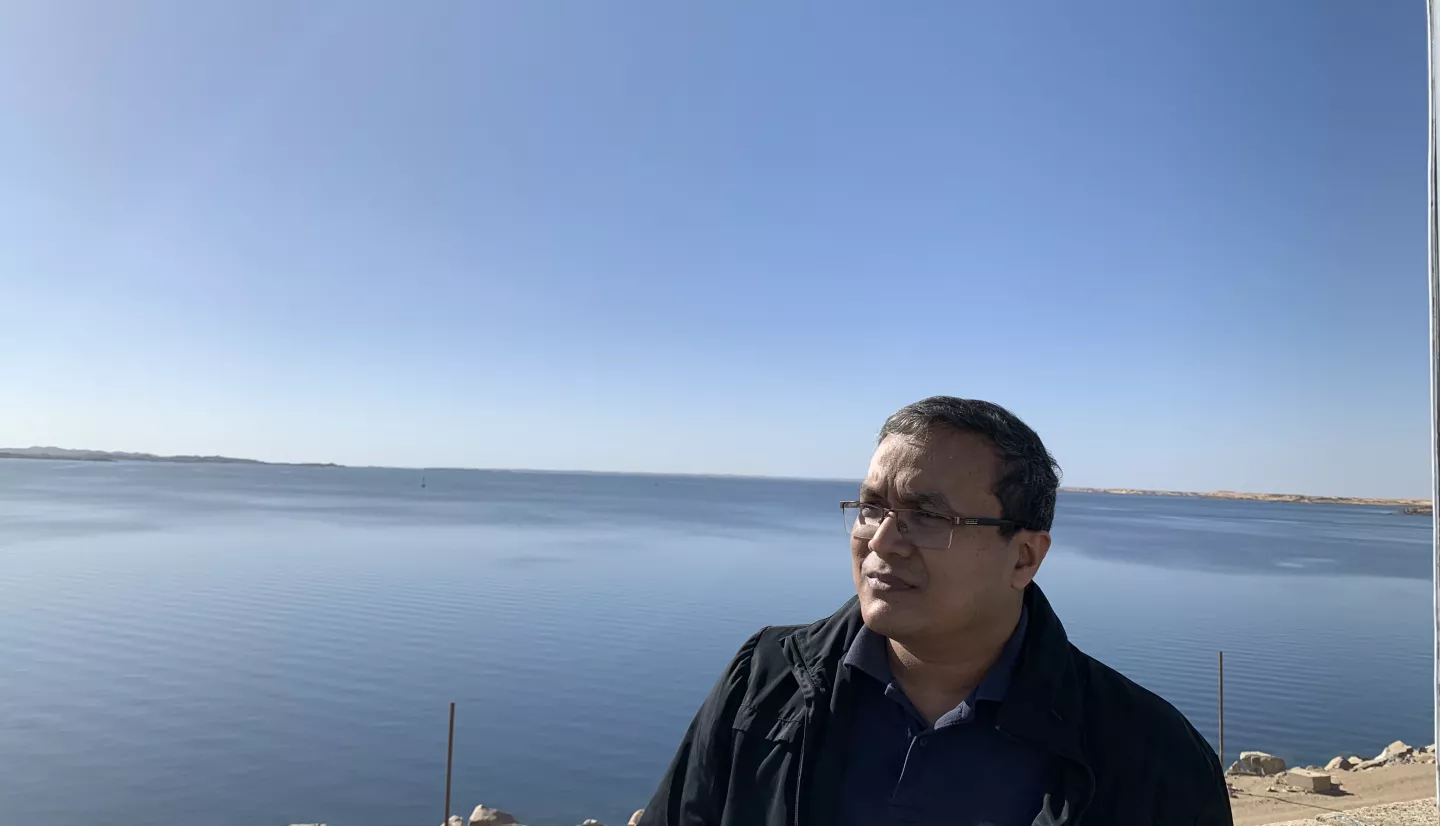 photo of man looking out over a large body of water