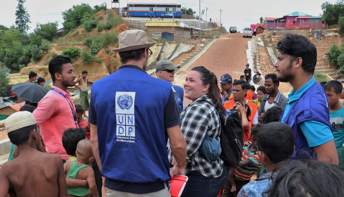 Shanna McClain speaks with a member of the United Nations Development Programme at a Rohingyan refugee camp. NASA provided the displaced community with data to reduce landslide risk in the refugee camps. NOTE: Some details in this photograph have been digitally obscured. Credits: NASA/Shanna McClain