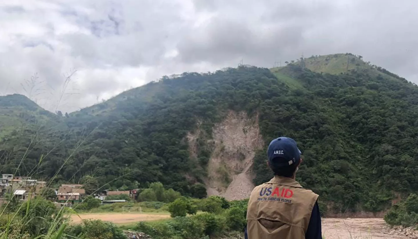 A humanitarian worker from USAID observes the impacts of a landslide. USAID deployed an elite Disaster Assistance Response Team on Nov. 17, 2020, to lead the U.S. response to Hurricanes Eta and Iota. Credits: USAID’s Bureau for Humanitarian Assistance