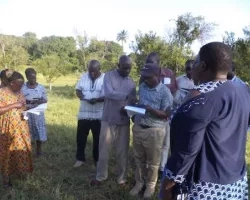 Remote Sensing Expert Antony Ndubi, center, helping participants during fieldwork training.