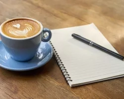 Cup of coffee and notebook