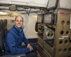 Photo of scientist Kristopher Bedka with laser