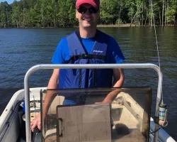 Man driving boat on lake