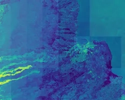 Normalized Difference Moisture Index (NDMI) processed 2021 Landsat 8 OLI imagery over land and Sentinel-2 MSI over ocean, ranging from yellow (low) to blue (high), for Hilo, Hawaii. Overlayed with four-day rainfall accumulation cells in blue acquired during Hurricane Lane (Aug 22-25, 2018) from CHIRPS Daily. NDMI monitors water content of leaves and is useful for classifying land cover. Impervious surfaces and areas that have received excessive historical rainfall are susceptible to future flood events.