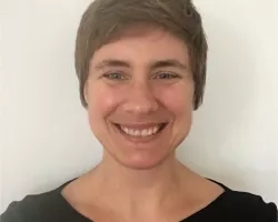 photo of white woman with short brown hair smiling at the camera