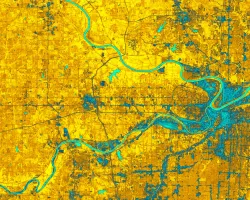 2010 – 2021 NDWI-processed imagery of the greater Kansas City, Kansas region. This image combines Landsat 5, 7, and 8 highlighting dry areas in yellow through orange. Areas classified as water are identifiable in aqua blue. Areas of darker blue are considered wet but include cityscape. A major problem for urban flooding identification is the mixture of cityscape in wet areas, making it important for further investigation and data processing.