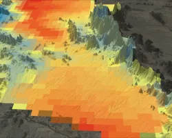 Aqua MODIS-derived nighttime land surface temperature climate normal for 2002–2022 across the southeastern portion of Organ Pipe Cactus National Monument. Shades of green and blue indicate lower mean nighttime temperatures while shades of orange and red indicate higher temperatures. Tinajas in areas with higher (red) nighttime temperatures are at risk of drying out. This data will help park managers prioritize conservation in identified areas as warming and drying trends continue across the western Sonoran 